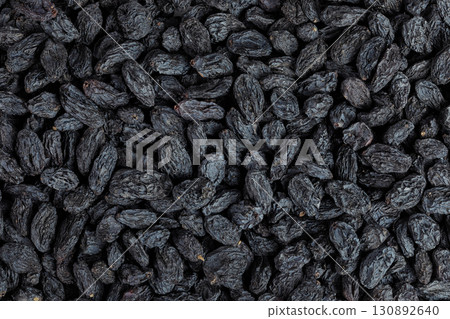 black raisins as a background. Top view. Flat lay black raisins as a background. Top view. Flat lay 130892640