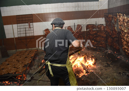 Gaucho roast barbecue, sausage and cow ribs, traditional argentine cuisine, Patagonia, Argentina. Gaucho roast barbecue, sausage and cow ribs, traditional argentine cuisine, Patagonia, Argentina. 130893007