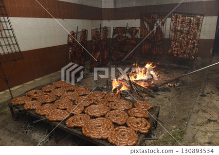 Barbecue, sausage and cow ribs, traditional argentine cuisine, Patagonia, Argentina. Barbecue, sausage and cow ribs, traditional argentine cuisine, Patagonia, Argentina. 130893534