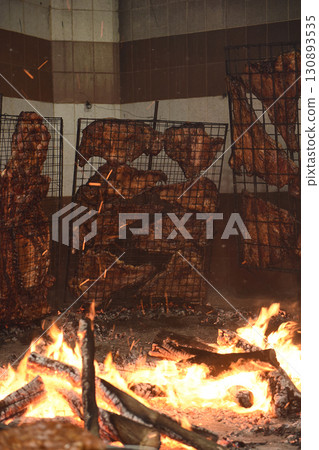 Barbecue, sausage and cow ribs, traditional argentine cuisine, Patagonia, Argentina. 130893535