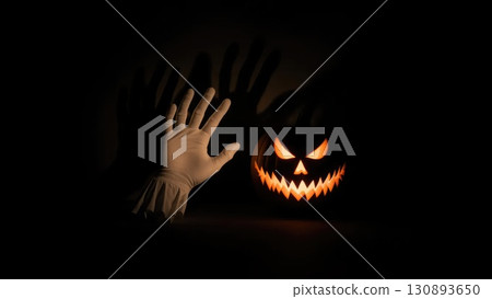 Minimalist Ghost Hands with Pumpkin Casting a Large Menacing Shadow Minimalist Ghost Hands with Pumpkin Casting a Large Menacing Shadow 130893650