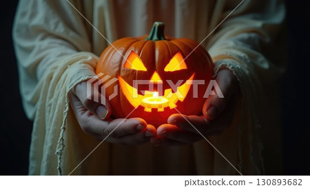 Ghost Hands Holding Glowing Jack-o-Lantern Pumpkin with Spooky Light Ghost Hands Holding Glowing Jack-o-Lantern Pumpkin with Spooky Light 130893682