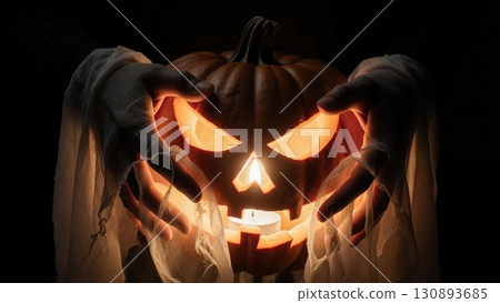 Ghost Hands Holding Glowing Jack-o-Lantern Pumpkin with Spooky Light Ghost Hands Holding Glowing Jack-o-Lantern Pumpkin with Spooky Light 130893685