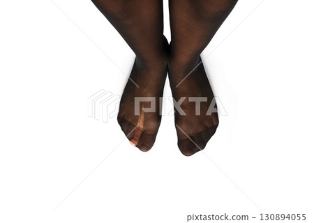 female legs in torn tights on white background, close-up, top view female legs in torn tights on white background, close-up, top view 130894055