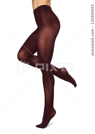 Beautiful long fit female legs in maroon tights on white background 130894083