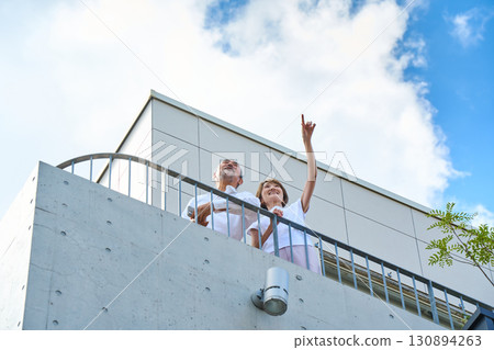 A wealthy middle-aged couple standing on the balcony 130894263