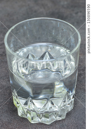 glass of water on black table glass of water on black table 130896590