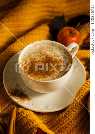 Cosy autumn coffee drink, with apples and cinnamon, orange pumpkins, wooden rustic background 130896733