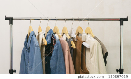 Collection of upcycled second-hand denim and fashion pieces displayed on a rack. Eco thrifting life. Collection of upcycled second-hand denim and fashion pieces displayed on a rack. Eco thrifting life. 130897019