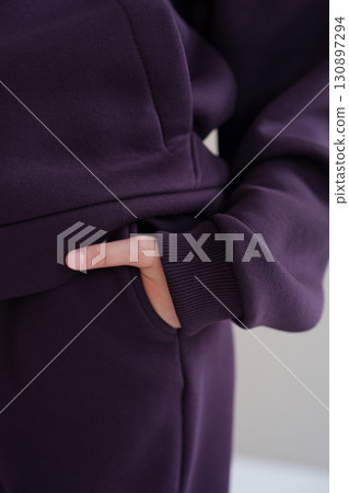 Purple hoodie with pocket and cuff. Close-up of sleeve of warm tracksuit. Purple hoodie with pocket and cuff. Close-up of sleeve of warm tracksuit. 130897294