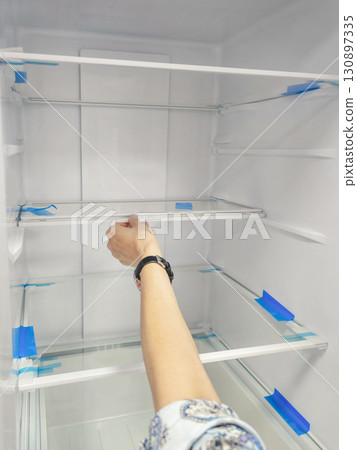 An empty refrigerator. Inside an empty 130897335