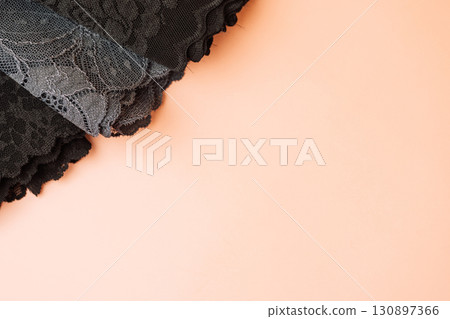 Black and gray lace trims on peach background Black and gray lace trims on peach background 130897366