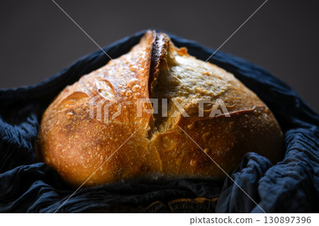 Appetizing sourdough bread with cracked crust and rugged texture 130897396