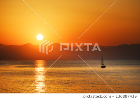 Small lonely fishing boat in calm water of Mediterranean sea 130897439