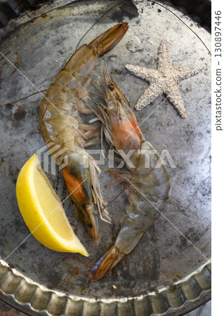 Two big shrimps with lemon in metal plate close up Two big shrimps with lemon in metal plate close up 130897446