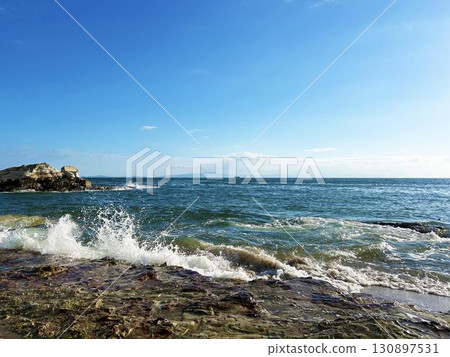 crashing waves and a refreshing blue sky 130897531