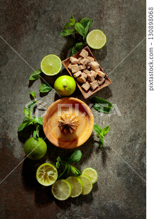 Wooden citrus squeezer and ingredients for making summer refreshing drinks. 130898068