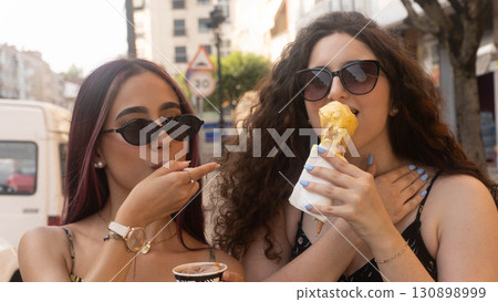 Friends Enjoying Ice Cream on the Street Friends Enjoying Ice Cream on the Street 130898999