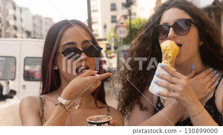 Friends Enjoying Ice Cream on the Street Friends Enjoying Ice Cream on the Street 130899000