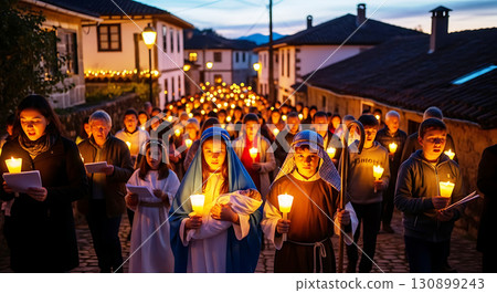 A group of people, including children, participate in a candlelit procession down a cobblestone street at dusk. They hold candles and wear costumes, illuminated by warm glowing lights A group of people, including children, participate in a candlelit procession down a cobblestone street at dusk. They hold candles and wear costumes, illuminated by warm glowing lights 130899243