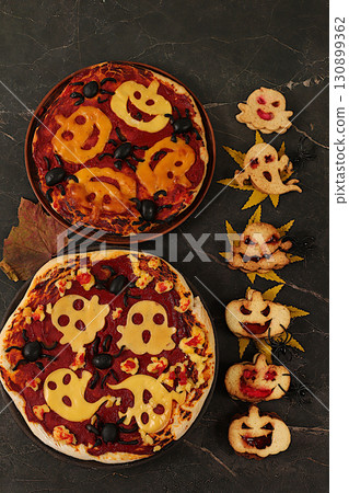 Halloween food concept, holiday meal idea for kids and adults. Scary pizzas and cookies in the form of monsters and ghosts on an old concrete background, cafe and menu advertising, Halloween food concept, holiday meal idea for kids and adults. Scary pizzas and cookies in the form of monsters and ghosts on an old concrete background, cafe and menu advertising, 130899362