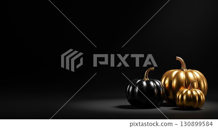 Dramatic, minimalist Halloween background with black and gold pumpkins on a dark surface 130899584