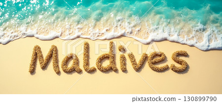 Sand letters form the word Maldives on a beautiful beach with waves gently washing ashore 130899790