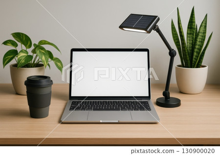 Modern workspace with laptop, coffee cup, and indoor plants during daylight hours 130900020