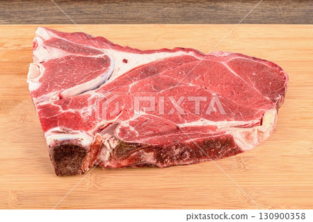 A piece of raw beef or veal meat on the bone. 130900358