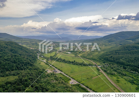 Green hills and forest landscape in summer. Chynadiieve, Ukraine. 130900601