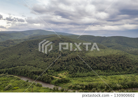 Green hills and forest landscape in summer. Chynadiieve, Ukraine. 130900602