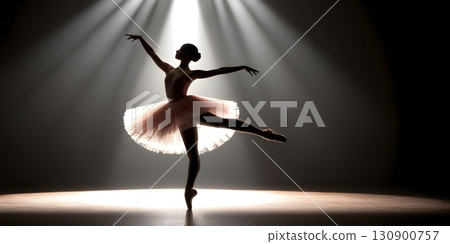 Silhouette of ballerina in graceful dance pose with glowing spotlight, cinematic elegant stage scene 130900757