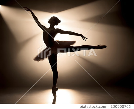 Silhouette of ballerina in graceful dance pose with glowing spotlight, cinematic elegant stage scene 130900765