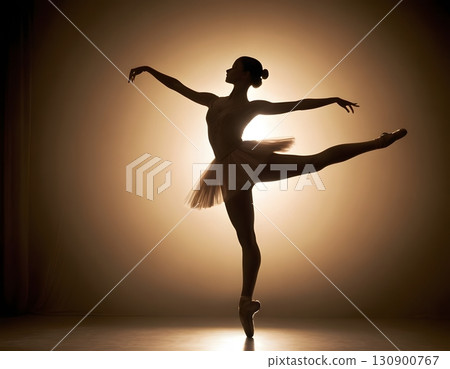 Silhouette of ballerina in graceful dance pose with glowing spotlight, cinematic elegant stage scene 130900767