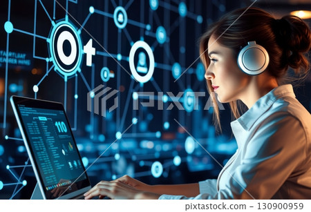 Woman works at a computer in the data center. 130900959