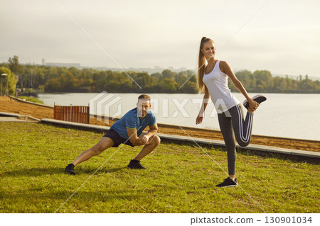 Young fit and active couple doing sport exercising in nature. Outdoors fitness concept. Young fit and active couple doing sport exercising in nature. Outdoors fitness concept. 130901034
