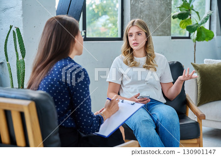 Young woman patient talking with female psychologist, mental counselor 130901147