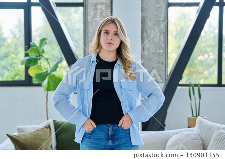 Portrait of young beautiful smiling woman in home interior Portrait of young beautiful smiling woman in home interior 130901155