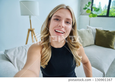 Selfie portrait happy beautiful young woman in home interior Selfie portrait happy beautiful young woman in home interior 130901167