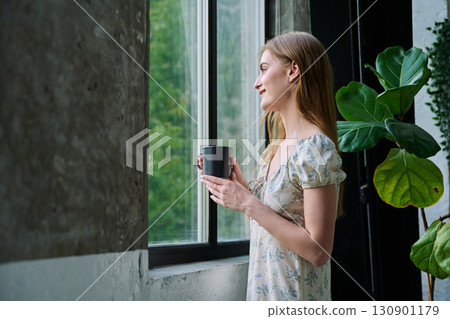 Young beautiful dreaming romantic girl looking out the window Young beautiful dreaming romantic girl looking out the window 130901179