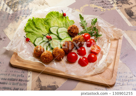 Crispy fried cheese balls on skewers 130901255