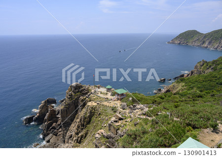 Steep mountain cliff with a gazebo and a national flag, and the South China Sea in Vietnam 130901413