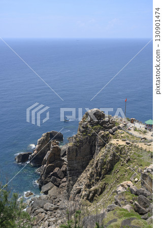 Steep mountain cliff with gazebo and national flag, and South China Sea to the horizon in Vietnam Steep mountain cliff with gazebo and national flag, and South China Sea to the horizon in Vietnam 130901474