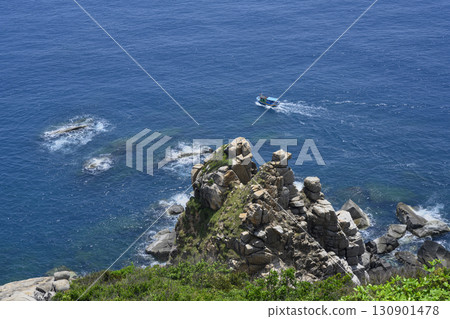 Aerial view of a steep mountain cliff, fishing boat and the South China Sea in Vietnam 130901478