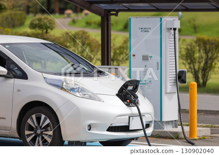 Electric vehicle charging at the charging station Electric vehicle charging at the charging station 130902040