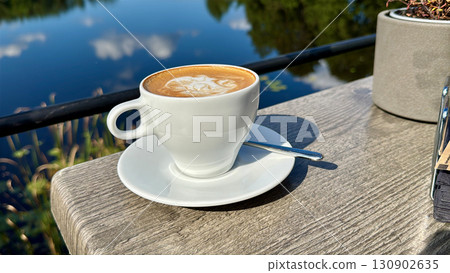 cappuccino cup on a sunny summer restaurant terrace 130902635