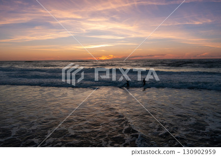 Two Surfer friends carving large breaking wave 130902959