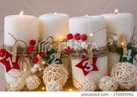 New year and Christmas preparation. Four-week advent candles on table. Handmade eco-friendly decor. Sustainable Christmas decoration New year and Christmas preparation. Four-week advent candles on table. Handmade eco-friendly decor. Sustainable Christmas decoration 130903062