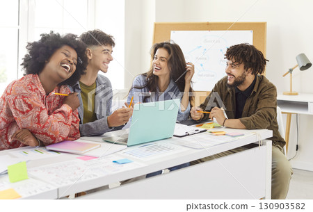 Smiling office diverse colleagues sitting gather in boardroom at desk with laptop to brainstorm Smiling office diverse colleagues sitting gather in boardroom at desk with laptop to brainstorm 130903582
