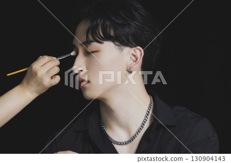 Young man putting on makeup 130904143